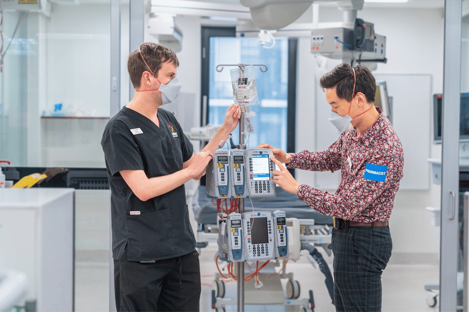ICU_male_nurse_and_pharmacist_with_med_pump.png